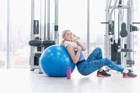 Young woman girl exercise workout in the gym using ballの写真素材