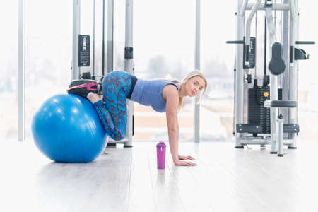 Young woman girl exercise workout in the gym using ballの写真素材