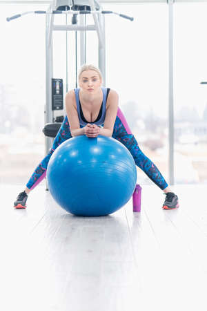 Young woman girl exercise workout in the gym using ballの写真素材