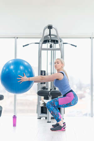 Young woman girl exercise workout in the gym using ballの写真素材