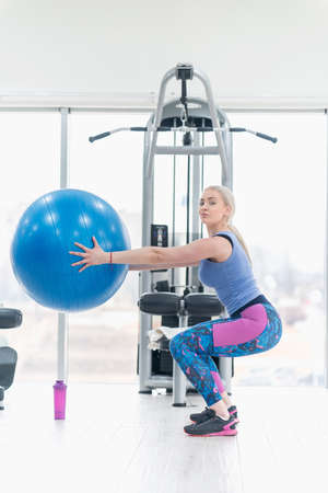 Young woman girl exercise workout in the gym using ballの写真素材