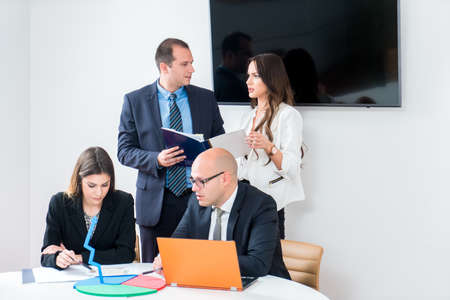 Startup business team on meeting in modern bright office interior mrainstorming. Working on laptop,...