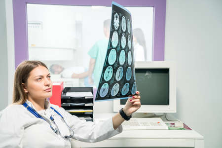Female doctor looking at an x-ray in her officeの写真素材