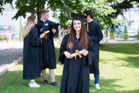 Happy woman on her graduation day University. Education and people. Friends class and classmatesの写真素材