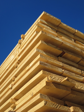 Stack of new wooden boards at the lumber yardの写真素材