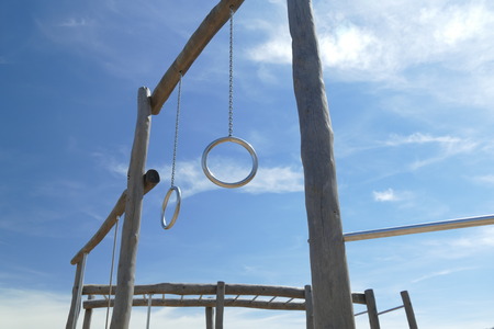two metal rings on wooden construction in children playgroundの写真素材