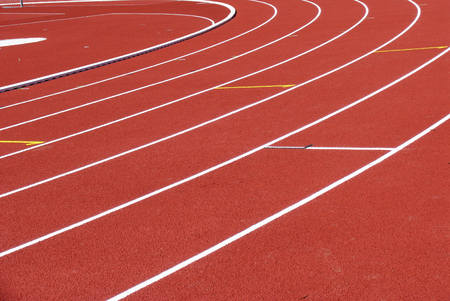 Red running track with white lines at the stadiumの写真素材
