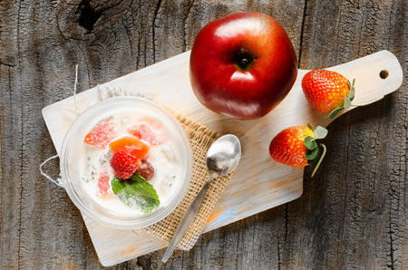 tofu fruit salad in plastic cup on woodenpadの写真素材