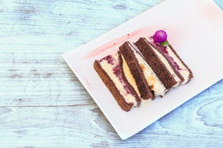 chocolate ice cream roll on white plate on wooden table