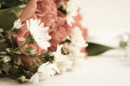 selective focus on white flower  with red bouguet processed retro style, represent lonely, miss, dowsy, lonesome, remembrance,の写真素材