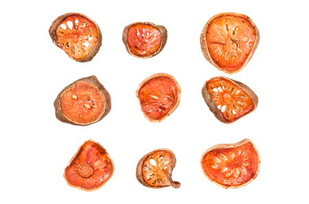 group of isolated dried bael fruit on white with clipping path for drinking.の写真素材