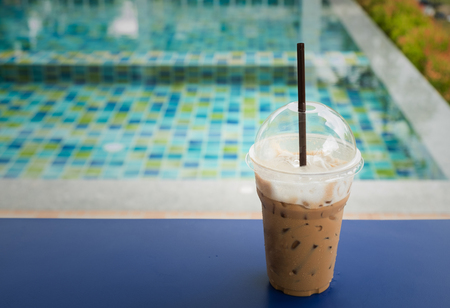 iced coffee with swimming pool background and copy space for any textの写真素材