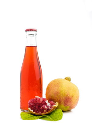 bottle of juice and pomegranate on white with clipping pathの写真素材