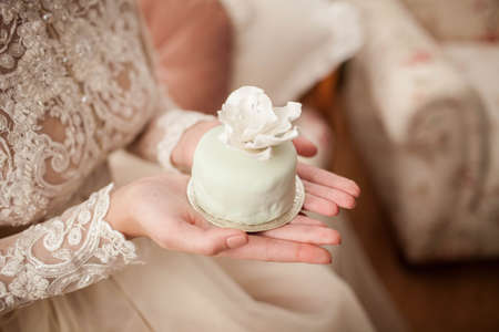 Bride is holding a cake in handsの写真素材