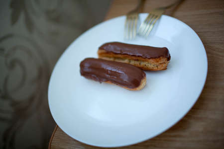 Two custard cakes lie on a plate. Dessert. Wedding