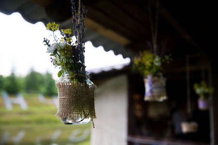 A bouquet of wild flowers hanging in the street. Close-up. Wedding decorations. Handmade.の写真素材