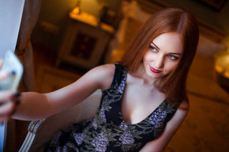 the red-haired girl makes a selfie