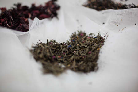 a bunch of green tea lies on white tableの写真素材