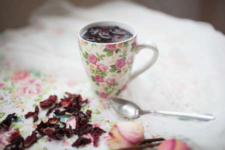 mug with red tea is on the tableの写真素材