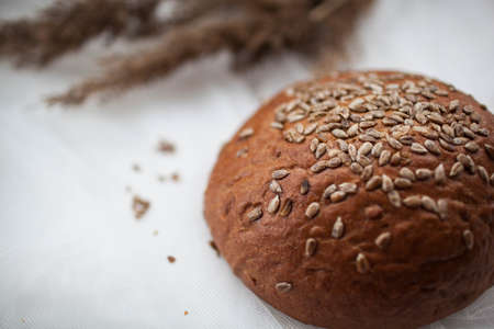 black round bread lies on a white tableの写真素材