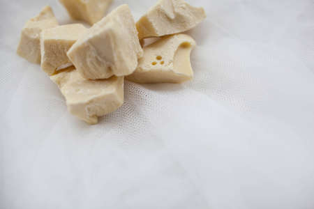 cocoa butter lying on white tableの写真素材
