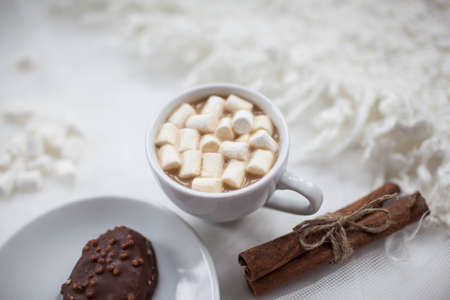 one white mug on a white background with marshmallowの写真素材
