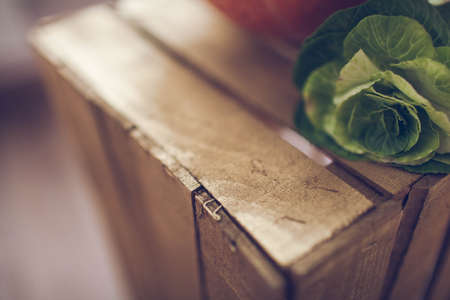Orange pumpkin and green cabbage lying on a wooden box. Background.の写真素材