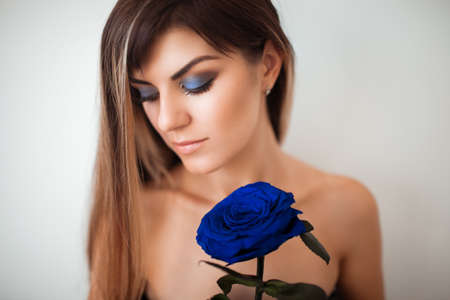 The girl holding a blue rose timelessの写真素材