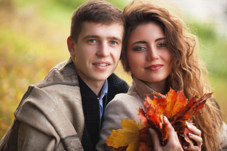 A guy and a girl walking in the autumn Parkの写真素材