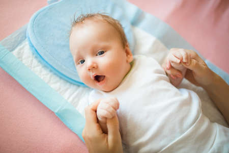 Newborn baby lying on the diaper and is happyの写真素材