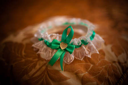 wedding garter lies on the bedの写真素材