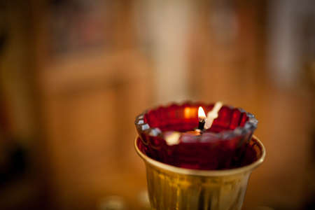 Burning red candle in the Orthodox Churchの写真素材