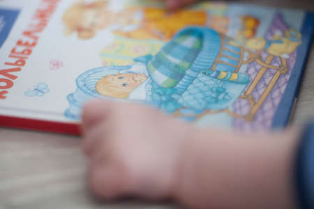 Hand the baby to a childrens book.の写真素材