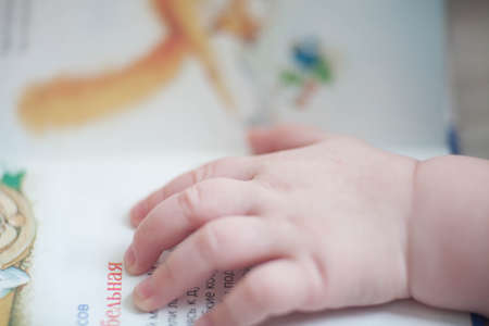 Hand the baby to a childrens book.