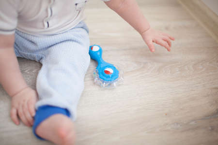 Baby boy toddler sitting and playing with toyの写真素材