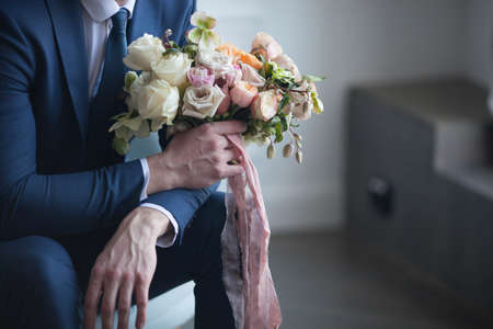 the groom holds a wedding bouquetの写真素材