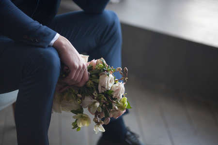 the groom holds a wedding bouquetの写真素材