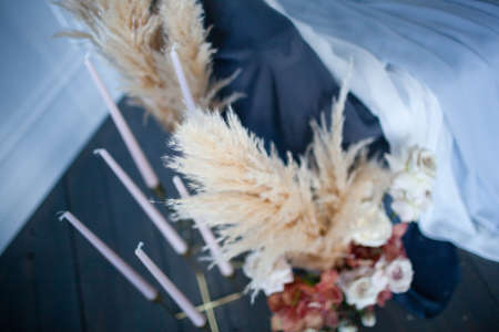 Long handmade candles in a candlestickの写真素材