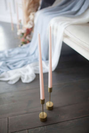Long handmade candles in a candlestickの写真素材