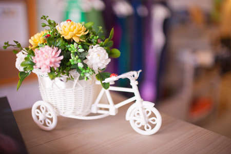 Basket with beautiful bouquet of spring flowers on wooden tableの写真素材