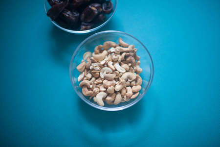 Cashew nuts in a transparent Cup on the table.の写真素材