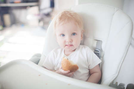 the child first eats breadの写真素材