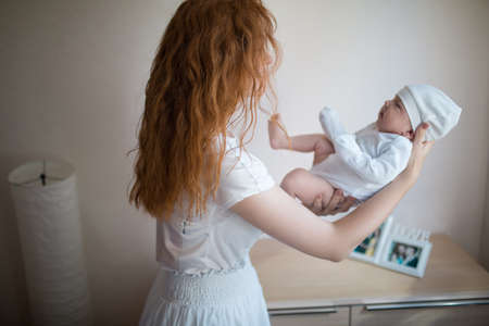 Mom is holding a newborn babyの写真素材