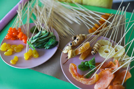 Young woman florist making fruit bouquetの写真素材