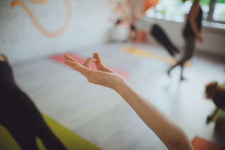 Young woman meditating indoorsの写真素材