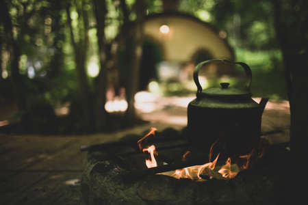 Metal teapot to boil on fire in the summer in the country.
