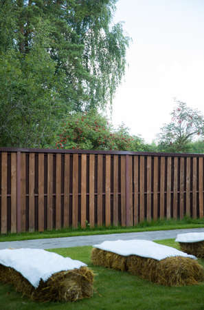 arch for the wedding ceremony of burlap and wooden logs in pine forestの写真素材
