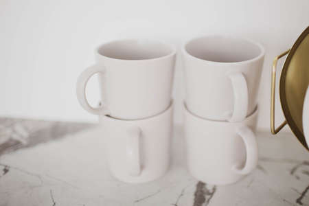 Beautiful stylish white mugs in the kitchen.の写真素材
