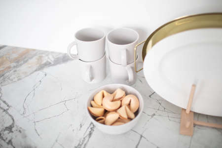 Cookies with wishes in a white plate on the kitchen table.の写真素材