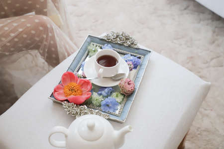 A beautiful white Cup of tea on a gold tray.Morning of the bride.の写真素材